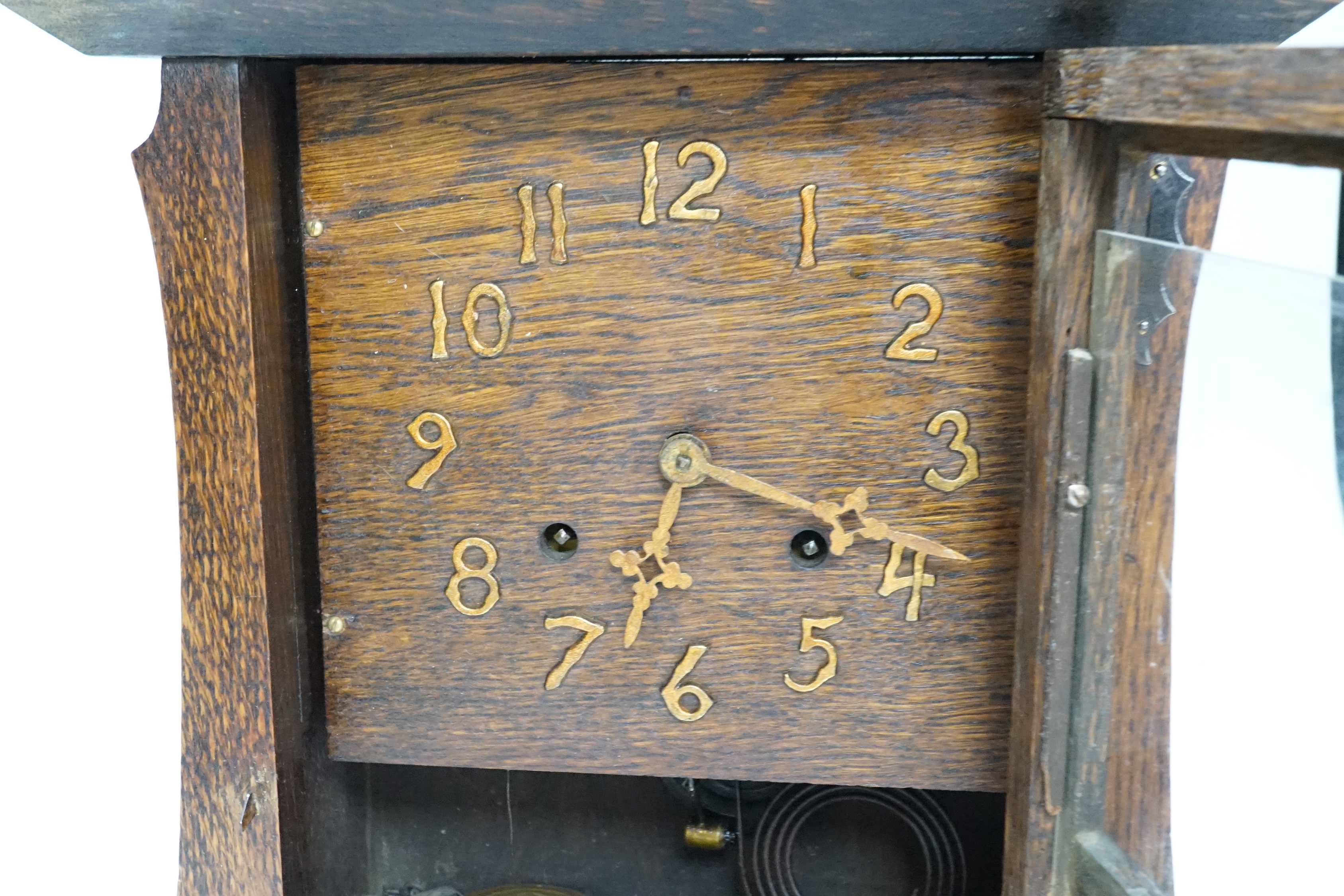 An American oak Arts and Crafts mantel clock, 35cm tall